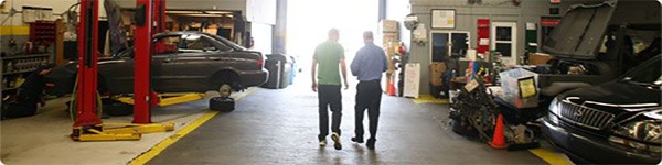 We get the job done right Workers walking through the shop at A+ Japanese Auto Repair in San Carlos, CA